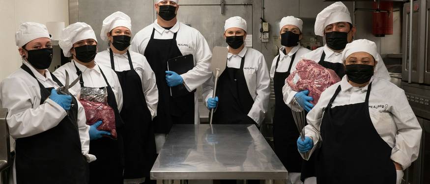 Ontario food handler trainees in a classroom or online learning environment, preparing for food safety certification